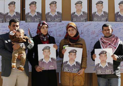 Relatives of Islamic State captive Jordanian pilot Muath al-Kasaesbeh hold pictures of him as they join students during a rally calling for his release, at Jordan University in Amman February 3