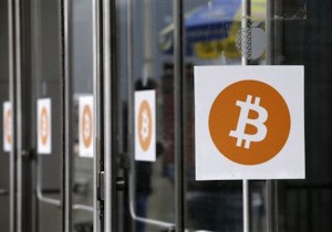 Bitcoin logos are displayed at the Inside Bitcoins conference and trade show, Monday, April 7, 2014 in New York