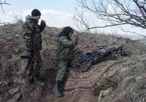 Pro-Russian rebels observe the area at a front line outside the village of Molochnoye, north-east from Donetsk