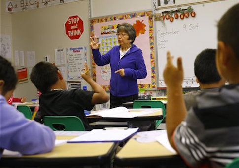 In this Sept. 9, 2014, photo, Joan Willow leads her classroom at Arapahoe Elementary School in Arapahoe, Wyo. on the Wind River Indian Reservation