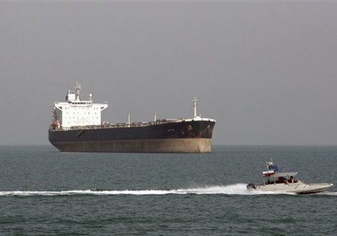 An Iranian Revolutionary Guard speedboat escorts a passenger ship in 2012