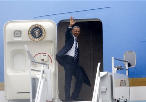 President Barack Obama waves as he enters Air Force One