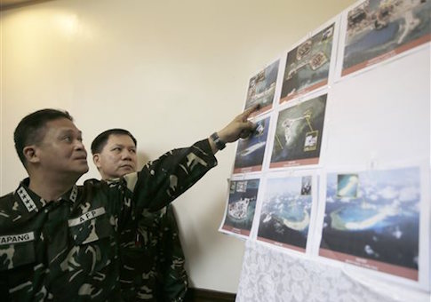 Armed forces of the Philippines Chief of Staff Gen. Gregorio Pio Catapang points to reveal recent images of China's reclamation activities being done at the disputed islands in the South China Sea during a news conference Monday, April 20