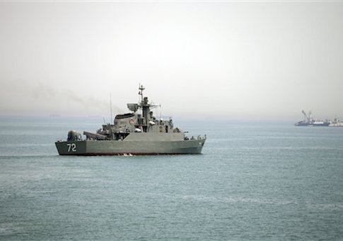 In this picture taken on Tuesday, April 7, 2015, and released by the semi-official Fars News Agency, Iranian warship Alborz, foreground, prepares before leaving Iran's waters, at the Strait of Hormuz