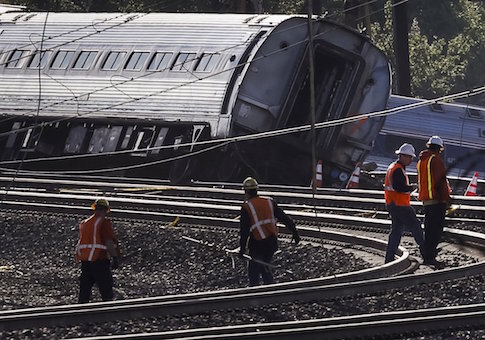 Officials survey the site of a derailed Amtrak train in Philadelphia, Pennsylvania