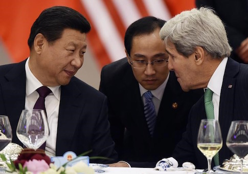 Chinese President Xi Jinping speaks with U.S. State Secretary John Kerry, through a translator, during a lunch banquet in the Great Hall of the People in Beijing