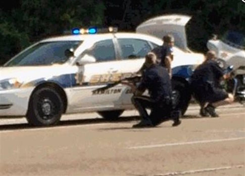 In this image made from video and released by WRCB-TV, authorities work an active shooting scene on amincola highway near the Naval Reserve Center, in Chattanooga, Tenn. on Thursday, July 16,