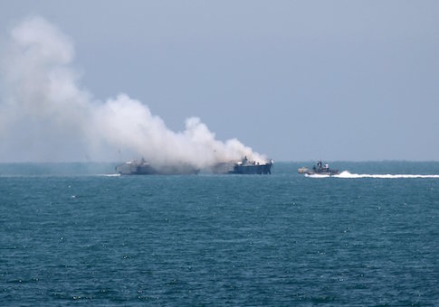 Smokes rises from an Egyptian coastguard vessel on the coast of northern Sinai, as seen from the border of southern Gaza Strip with Egypt