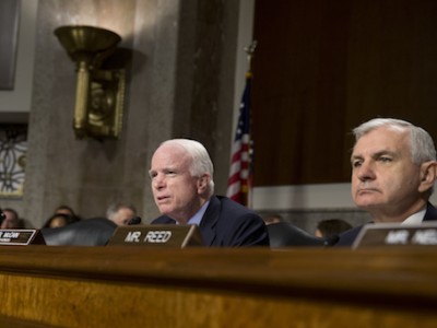 Senate Armed Services Committee Chairman Sen. John McCain, R-Ariz., joined by the committee's ranking member Sen. Jack Reed, speaks during the Senate Armed Services Committee hearing on Capitol Hill in Washington, Tuesday, July 7