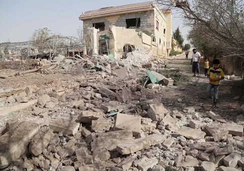 Civilians inspect a site hit by what activists said were air strikes carried out by the Russian air force on Reef al-Mohandeseen area in the western countryside of Aleppo, Syria