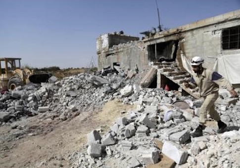 A civil defence member walks on rubble of a damaged building next to a site hit by what activists said were airstrikes carried out by Russian air force at Ehsim town in the southern countryside of Idlib, Syria