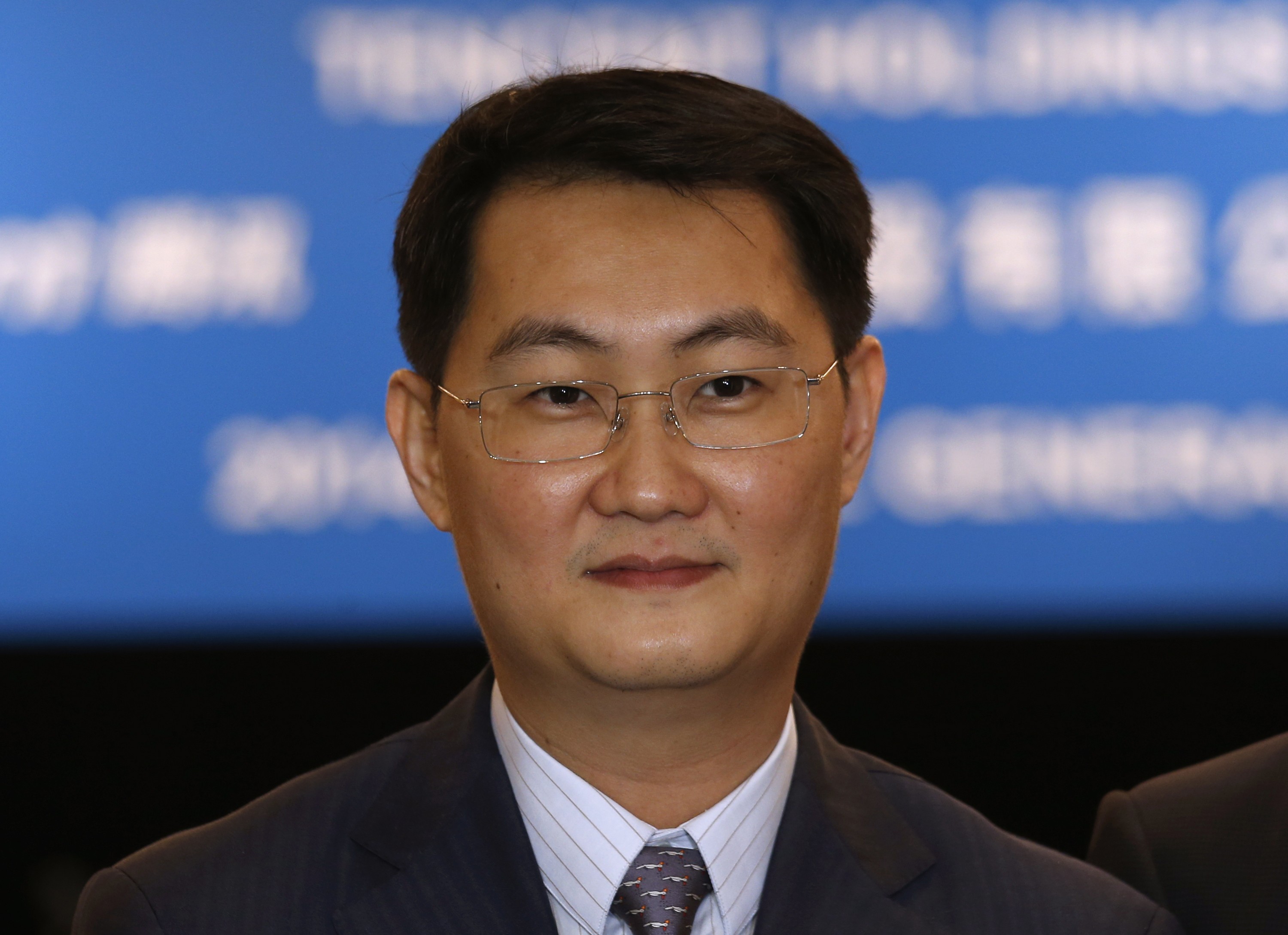 Tencent Chief Executive Officer Pony Ma poses before attending the company's annual general meeting in Hong Kong in this May 14, 2014 file photo. Alibaba and Tencent spent more than $8 billion last year alone backing often strikingly similar ventures, as the Chinese Internet giants race to create online one-stop-shops to win the digital loyalty of a tenth of the world's population. REUTERS/Bobby Yip/Files (CHINA - Tags: BUSINESS HEADSHOT TELECOMS SCIENCE TECHNOLOGY)