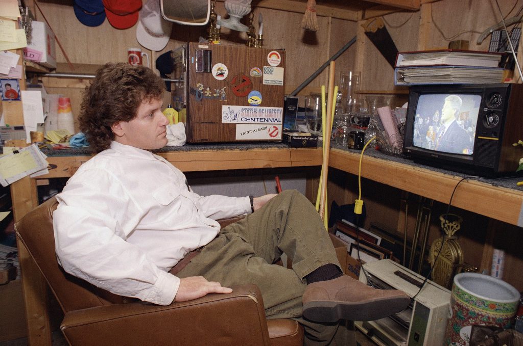 Roger Clinton watches his brother, presidential candidate Bill Clinton, on television during the second presidential debate. He was in a make-up room on the set of Designing Women at Warner Brothers studios in Burbank, California on Thursday, Oct. 15, 1990 where Clinton sings in a warm-up band for the audience on the set. (AP Photo/Mark J. Terrill)