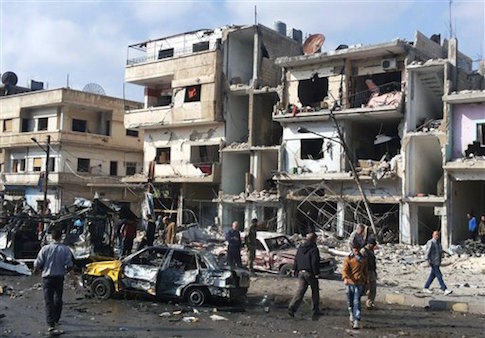 Syrian citizens gather at the scene where two blasts exploded in the pro-government neighborhood of Zahraa, in Homs province, Syria in Feb. 2016 / AP