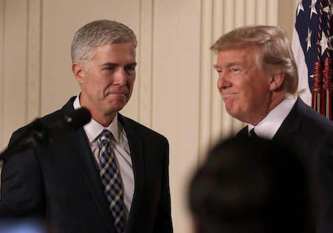 U.S. President Donald Trump looks on as Neil Gorsuch (L) approaches the podium after being nominated to be an associate justice of the U.S. Supreme Court at the White House in Washington