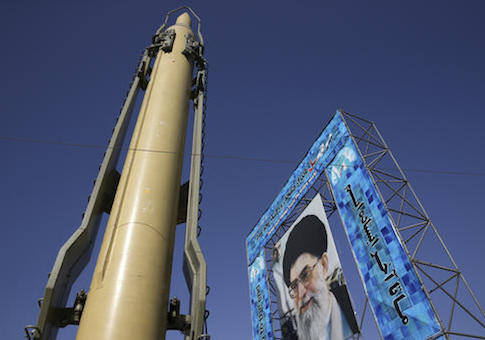 A Ghadr-F missile is displayed next to a portrait of Iranian Supreme Leader Ayatollah Ali Khamenei at a Revolutionary Guard hardware exhibition