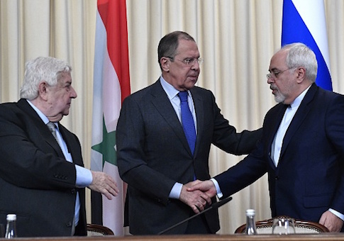 Russian Foreign Minister Sergei Lavrov shakes hands with his Iranian counterpart Mohammad Javad Zarif as Syrian Foreign Minister Walid Muallem looks on after a joint press conference