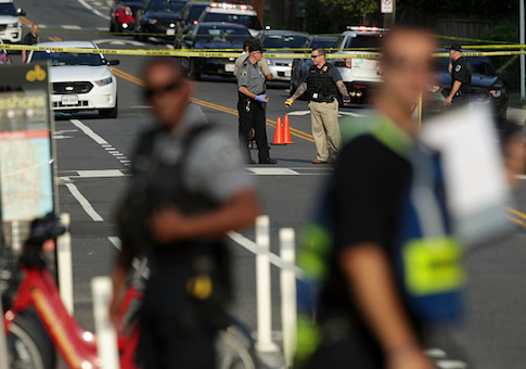 Investigators gather near the scene of a shooting June 14, 2017 in Alexandria, Virginia