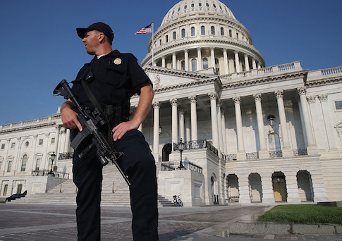 A U.S. Capitol Police officer stands guard in front of the U.S. Capitol Building