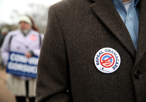 A protester wears a Repeal Obamacare button on his jacket