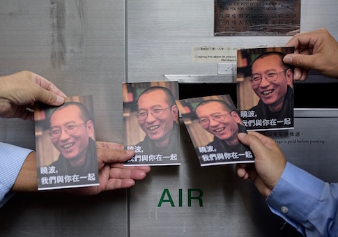 Protestors prepare to post postcards written and addressed to terminally-ill Chinese Nobel laureate Liu Xiaobo outside the General Post Office in Hong Kong