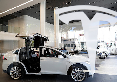 A Tesla Model X is displayed inside of the new Tesla flagship facility