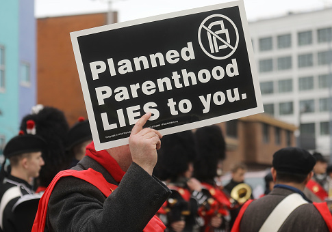 Anti-abortion protestors gather at a demonstration outside a Planned Parenthood office on February 11, 2017 in Washington, DC. / Getty Images