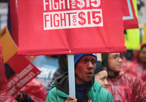 Demonstrators fighting for a $15-per-hour minimum wage march through downtown during rush hour on May 23, 2017 in Chicago