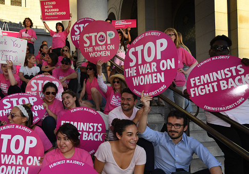 Supporters and patients of Planned Parenthood take part in a "Pink the Night Out" rally at City Hall, in Los Angeles, California on June 21, 2017. MARK RALSTON/AFP/Getty Images