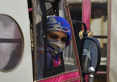 A Pakistani woman looks out from a pink rickshaw at a rally to rise awareness of women's equality and empowerment on Oct. 14, 2017 / Getty Images