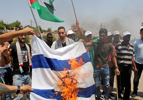 Lebanese and Palestinian youths burn a make-shift Israeli flag
