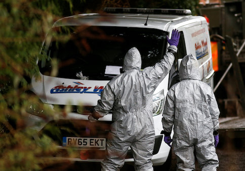 Soldiers wearing protective suits work at a site in Winterslow, near Salisbury, Britain