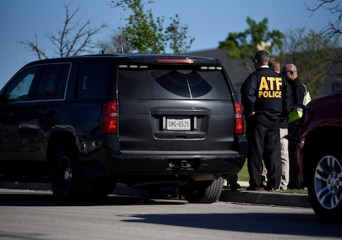 Law enforcement personnel attend the scene of a blast at a FedEx facility in Schertz, Texas