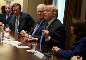 U.S. President Donald Trump speaks as Rep. Brian Mast, Sen. Christopher Murphy, Senate Majority Whip Sen. John Cornyn, and Sen. Dianne Feinstein listen during a meeting with bipartisan members of Congress