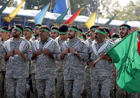 Iranian members of the Basij militia march during a parade
