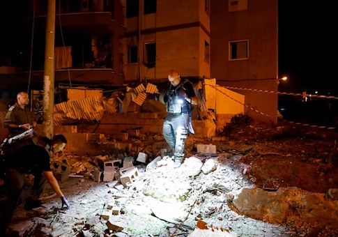 Israeli emergency personnel gather at the site of rocket attack in the southern Israeli town of Ashdod