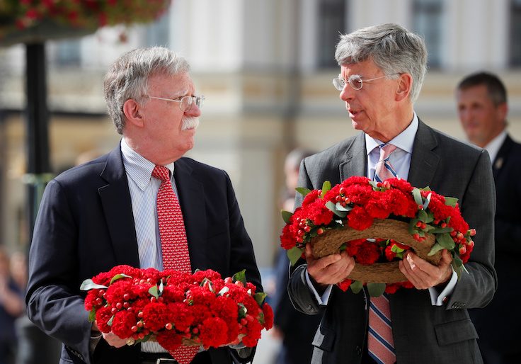 U.S. National Security Adviser John Bolton and U.S. Embassy Charge d'Affairs William Taylor attend a wreath-laying ceremony at the memorial for soldiers killed in a recent conflict in eastern Ukraine