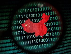 FILE PHOTO: A map of China is seen through a magnifying glass on a computer screen showing binary digits in Singapore