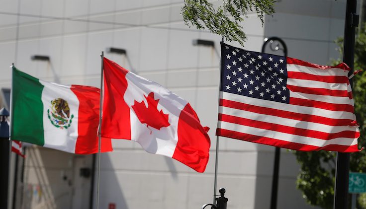 Flags of the U.S., Canada and Mexico fly next to each other in Detroit, Michigan