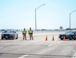 Florida State Troopers block traffic over the Bayou Grande Bridge leading to the Pensacola Naval Air Station