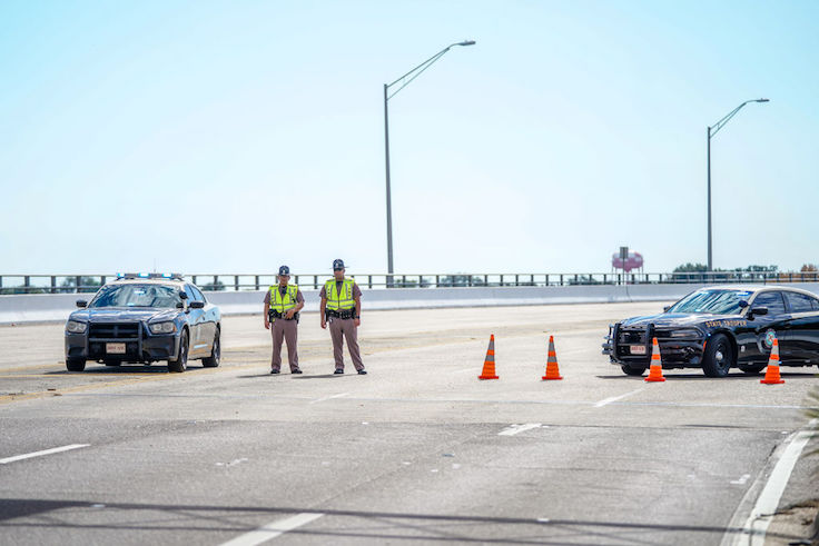 Florida State Troopers block traffic over the Bayou Grande Bridge leading to the Pensacola Naval Air Station