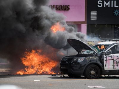 Police vehicles burn