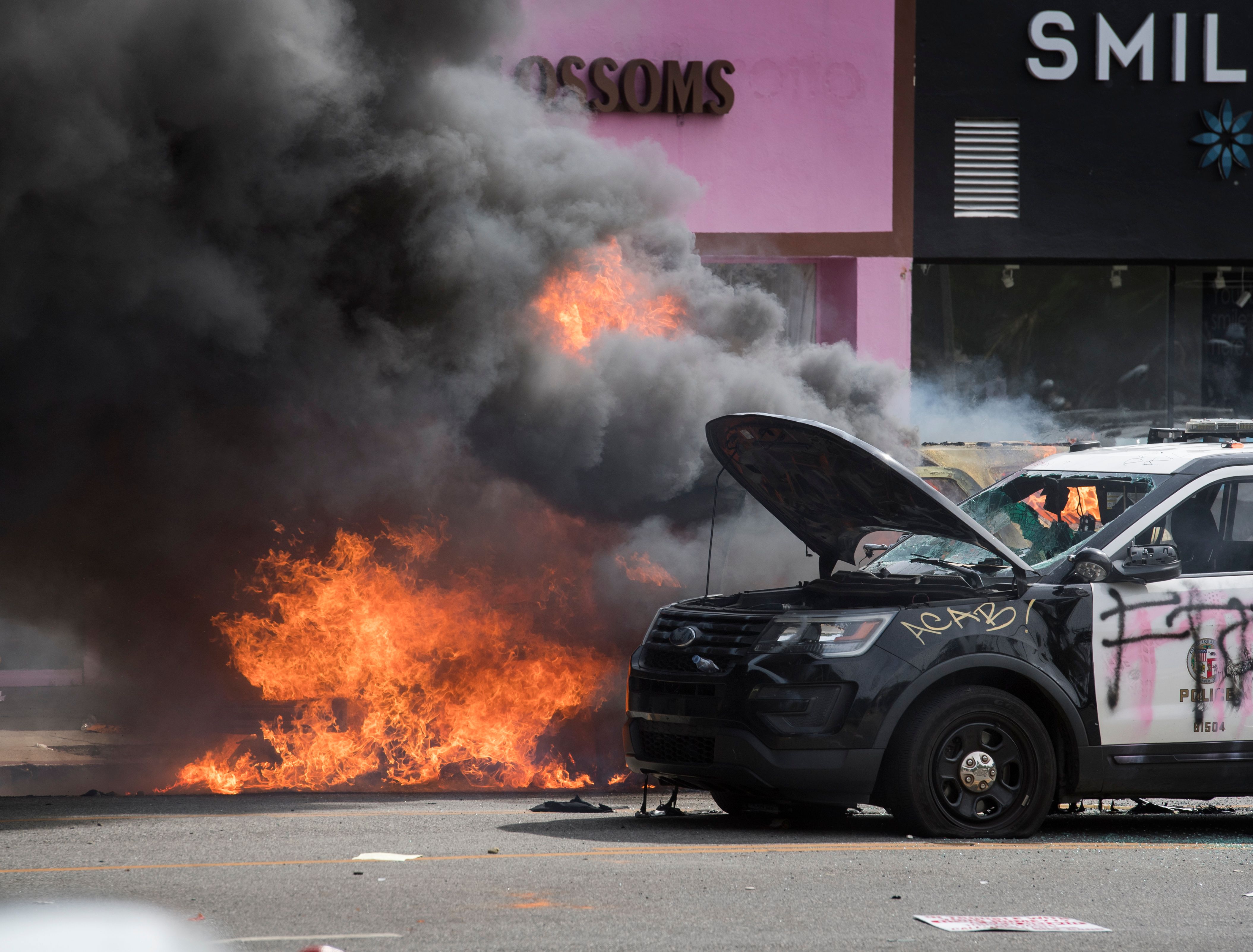 Police vehicles burn