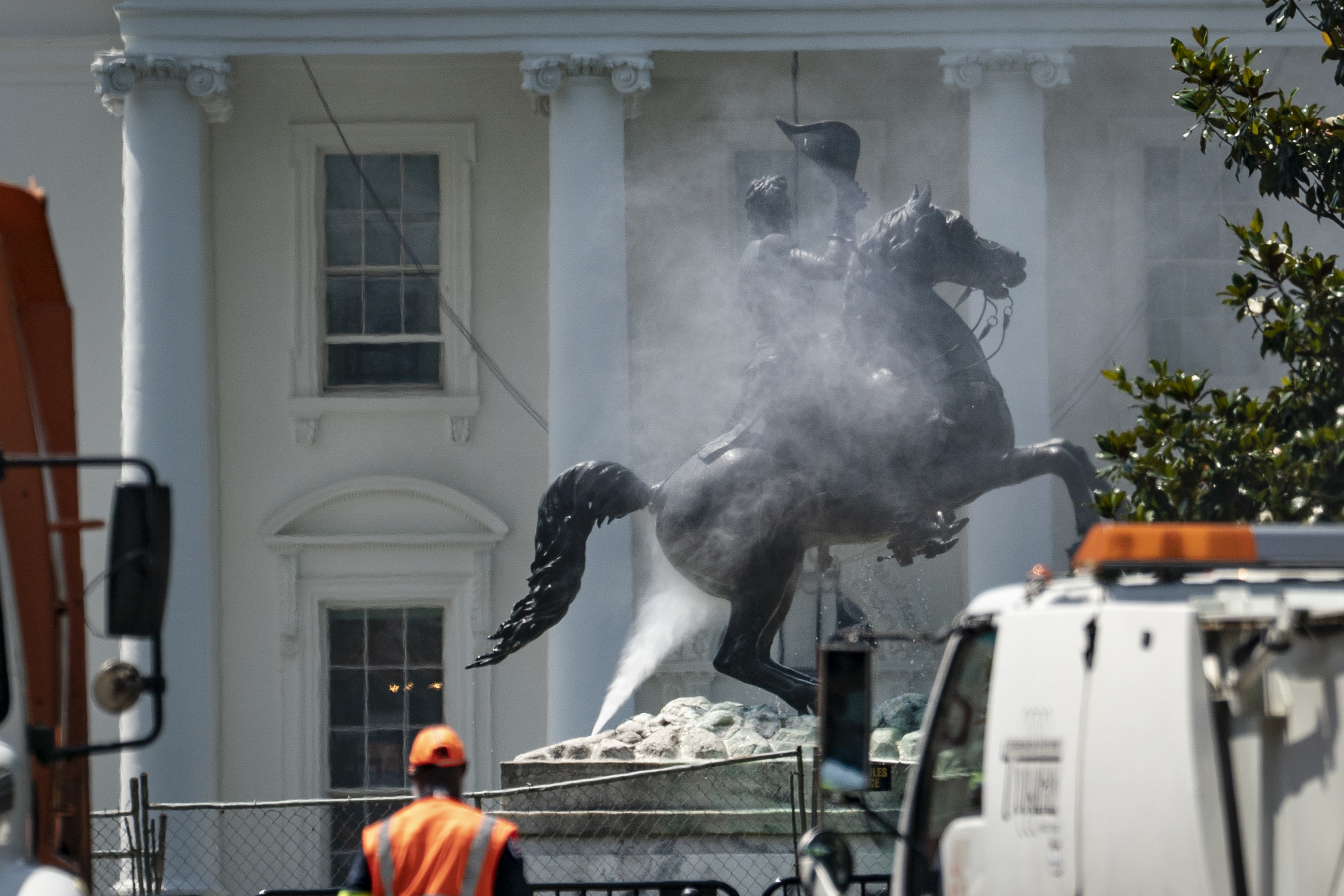 Workers clean the statue of Andrew Jackson in Lafayette Square