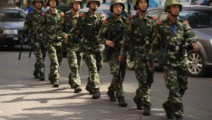 Chinese paramilatary police patrol on a street in Urumqi, capital of China's Xinjiang region
