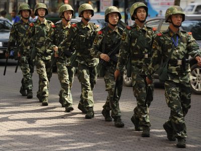 Chinese paramilatary police patrol on a street in Urumqi, capital of China's Xinjiang region