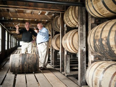 Eddie Russell and his father Jimmy sample bourbon inside Wild Turkey's rickhouse in Lawrenceburg, Ky.